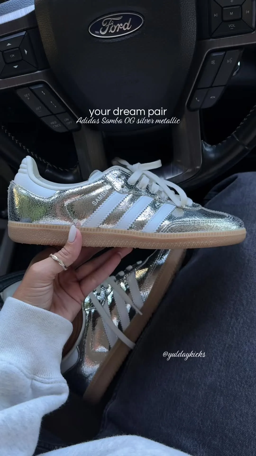 Silver metallic Adidas Samba OG held up by Yul Day